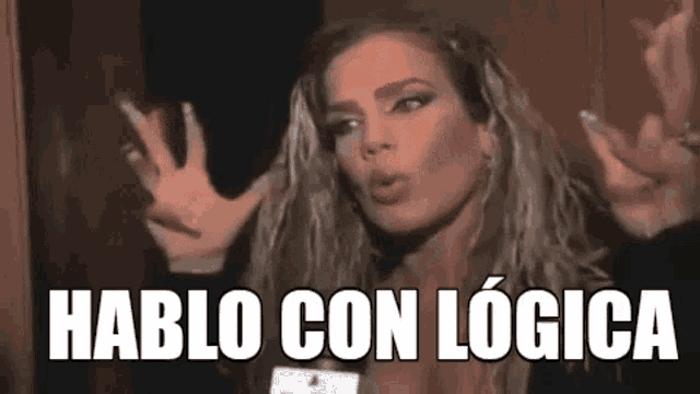a woman is making a funny face and saying `` hablo con logica '' with her hands in the air .