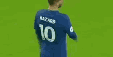 a soccer player wearing a blue shirt with the number 10 on it is walking on a field .