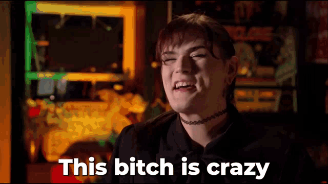 a woman with a choker on her neck is making a funny face and says " this bitch is crazy "