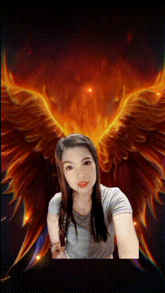 a woman is taking a selfie in front of a fire background