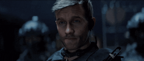 a close up of a man 's face with a gun