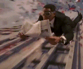 a man in a suit is reading a newspaper while laying on a railing