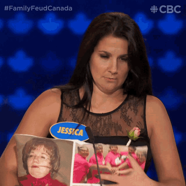 a woman with a name tag that says jessica is holding a picture of a child