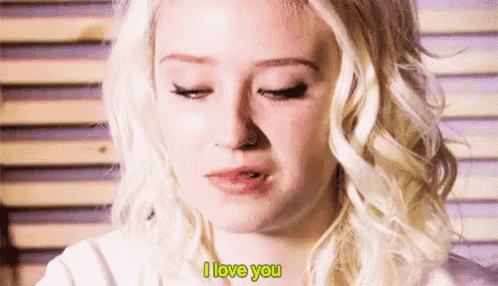 a close up of a woman 's face with the words `` i love you '' written on it .