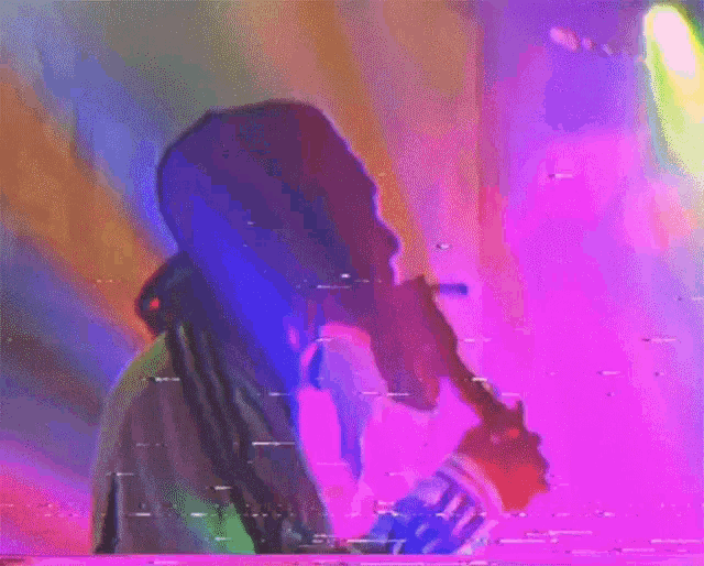 a blurry picture of a man holding a microphone