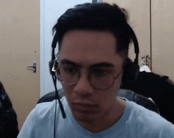 a man wearing glasses and headphones looks at the camera .