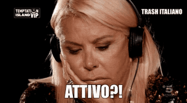 a woman wearing headphones says " attivo " in a foreign language