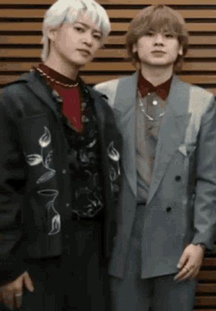 a couple of young men standing next to each other