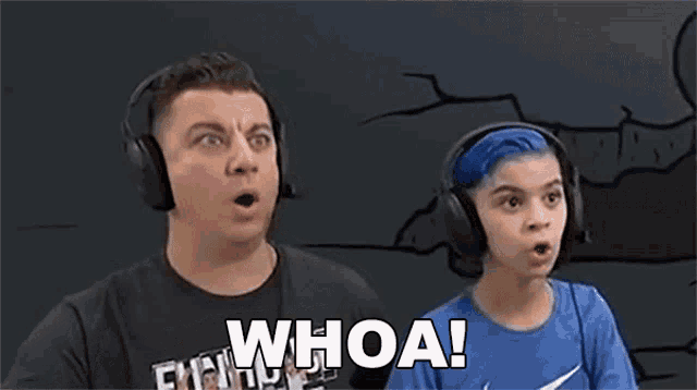 a man and a boy wearing headphones and a shirt that says `` whoa '' .