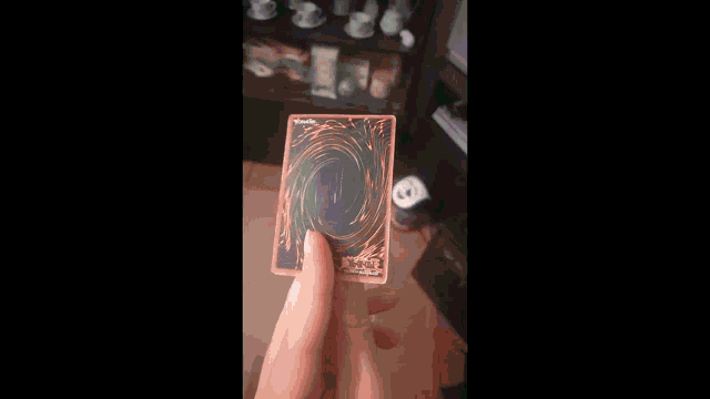 a person holding a card that says menacing on the bottom