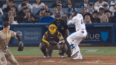 a baseball player with the number 4 on his jersey swings at a ball
