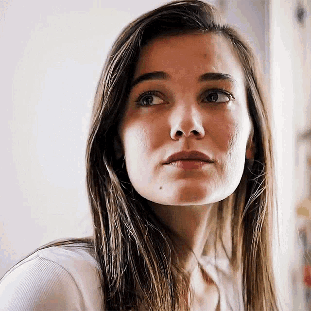 a close up of a woman 's face with her eyes closed