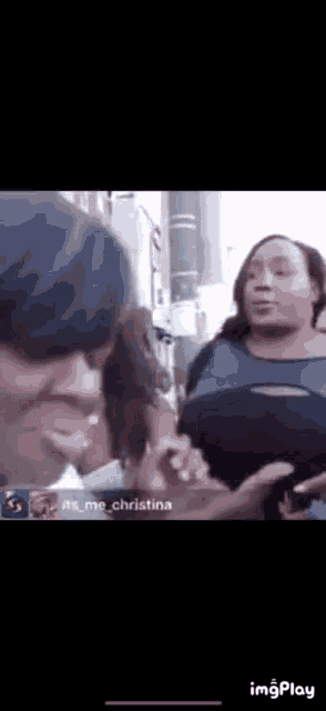 a group of women are standing next to each other on a sidewalk .