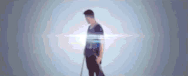 a blurry picture of a man standing in front of a white background .
