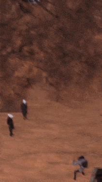 a blurry picture of people walking on a hillside