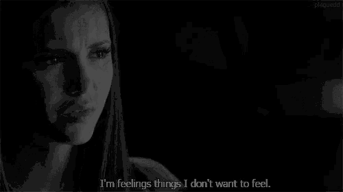 a woman is crying in the dark with the words `` i 'm feelings things i don 't want to feel ''