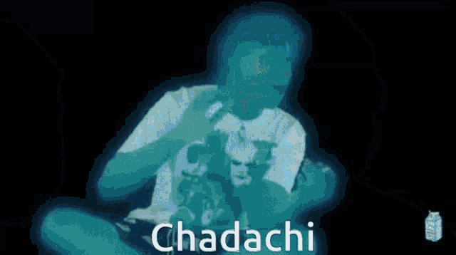 a man in a white shirt is playing a video game and the word chadachi is above him