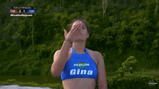 a woman wearing a blue top with gina on it