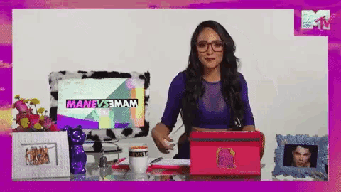 a woman sitting at a desk in front of a computer screen that says manevesmam
