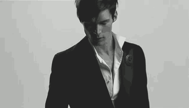 a black and white photo of a man in a tuxedo