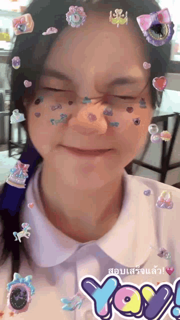 a girl with stickers on her face and a yoy logo in the corner
