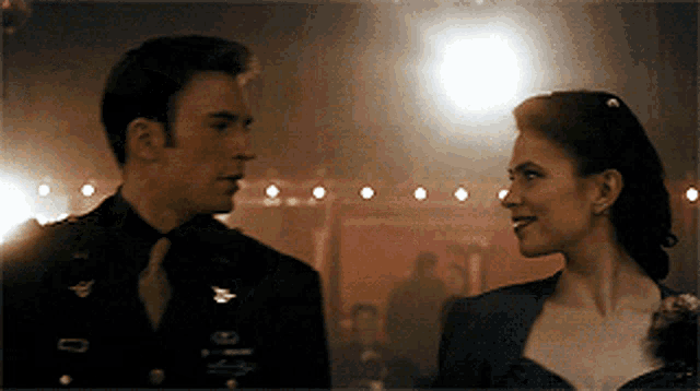 a man and a woman are looking at each other