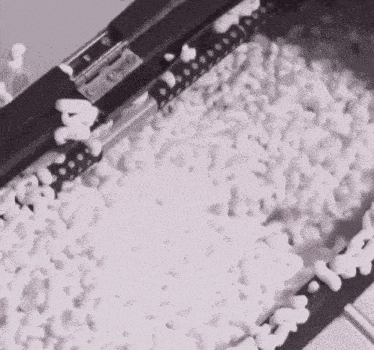 a black and white photo of a machine that is filled with white foam