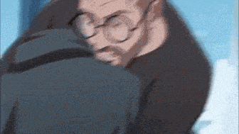 a man with glasses and a beard is hugging another man .