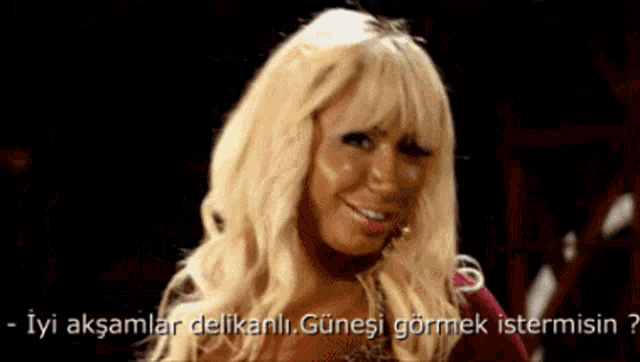 a woman with blonde hair is smiling with the words iyi aksamlar delikanli günesi gormek istermisin
