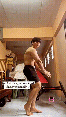 a shirtless man is doing a back + biceps workout in a room