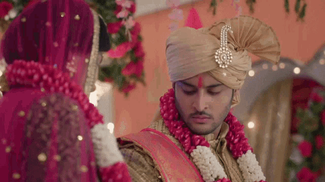 a bride and groom standing next to each other in a room