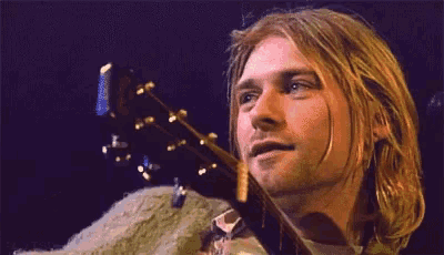 a close up of a man 's face with his eyes closed and a smile on his face .