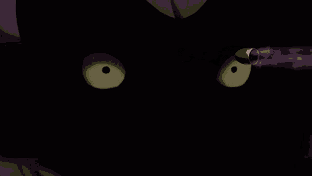 a close up of a cartoon character 's eyes with a purple lightning bolt coming out of them .