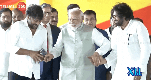 a group of men are standing around a man with a beard and a telugu 360 logo in the background