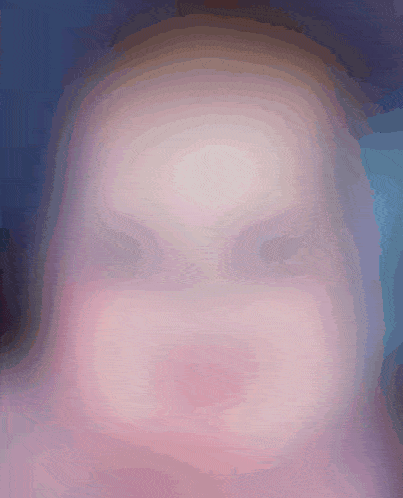 a blurry picture of a person 's face with a purple background