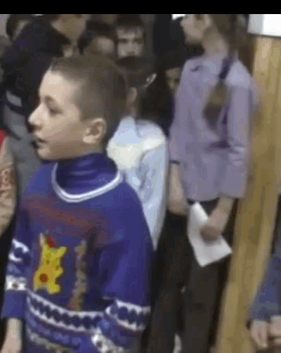 a boy wearing a purple sweater with a pikachu on it