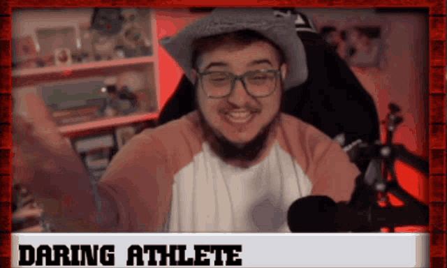 a man wearing glasses and a hat is sitting in front of a microphone with the words daring athlete on the bottom