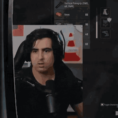 a man wearing headphones and a microphone looks at something