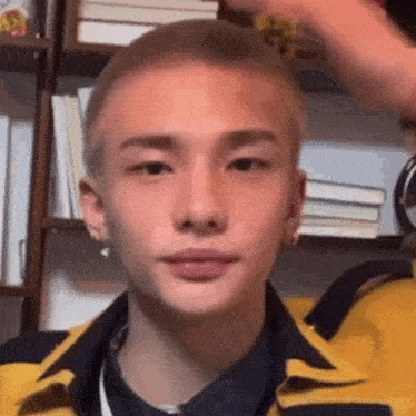 a close up of a man 's face with a shaved head .