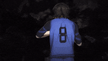 a boy with black hair and yellow eyes is pointing his finger at the camera