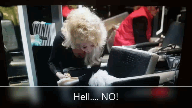 a woman is sitting in a chair with the words hell no on the screen