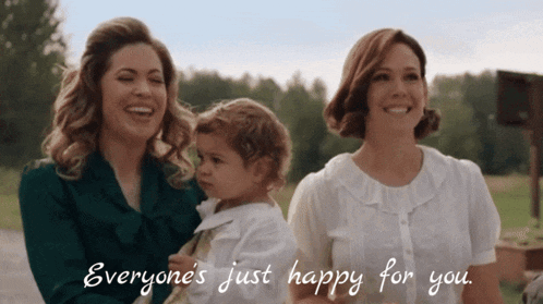 two women holding a baby with the words everyone 's just happy for you below them