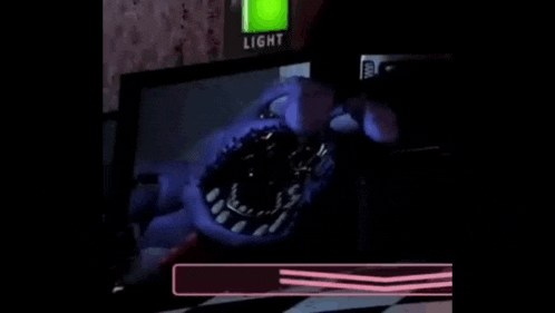 bonnie from five nights at freddy 's is looking at the camera in a dark room with his mouth open .
