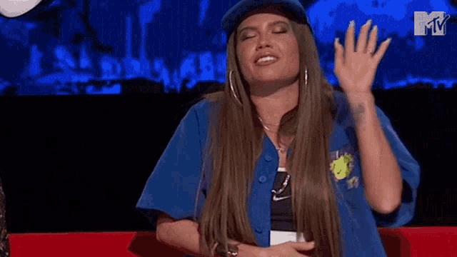 a woman is wearing a blue hat and a blue shirt .
