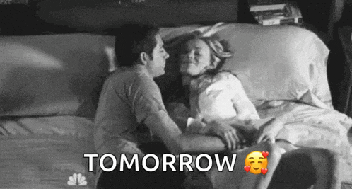 a black and white photo of a man and woman kissing on a bed with the words tomorrow written above them .