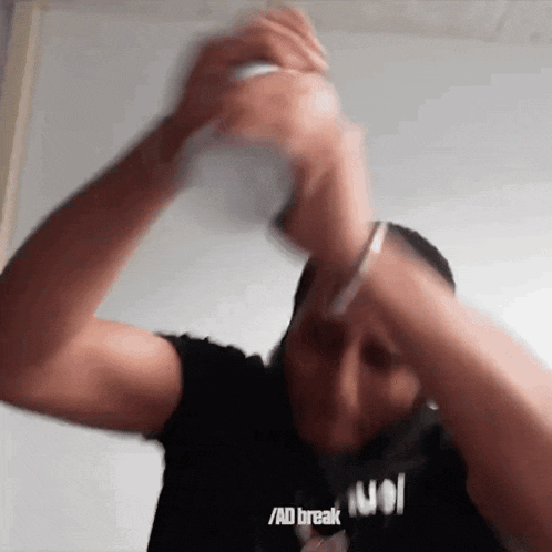 a blurry picture of a man wearing a black shirt that says / ad break