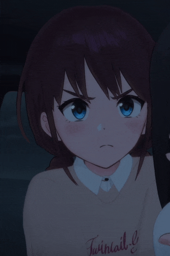 a close up of a girl with blue eyes making a face