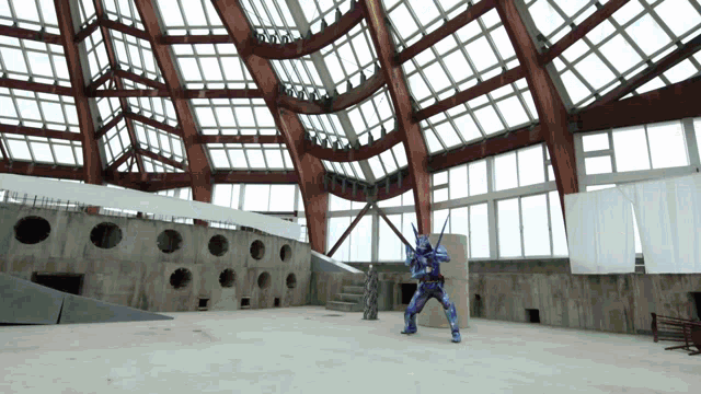 a man in a blue suit stands in a large building