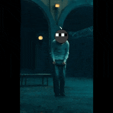 a man in a white sweater and grey pants is standing in the dark