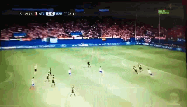 a soccer game between atl and bar is being played on a television screen